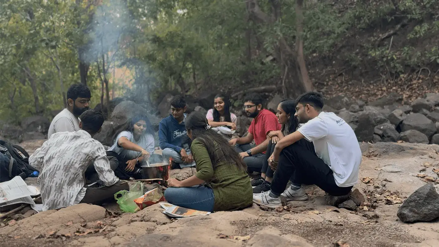 Group gathering around a campfire.